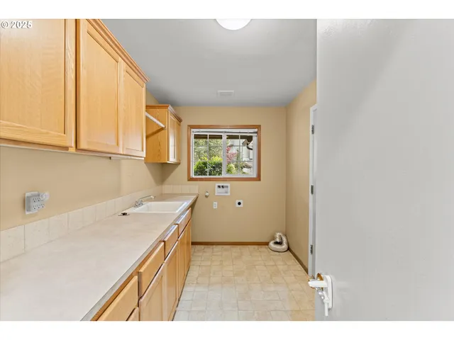 a room with a sink and cabinets