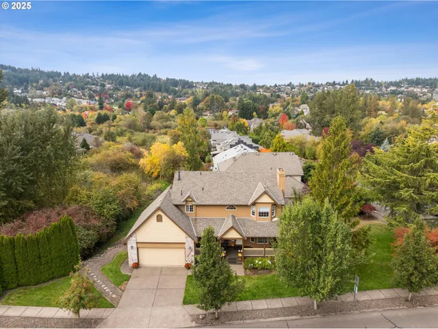 an aerial view of residential houses with outdoor space and trees