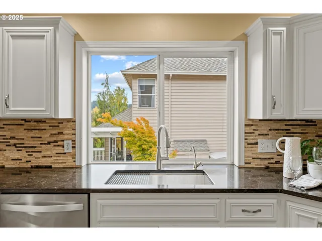 a kitchen with granite countertop a sink and a window