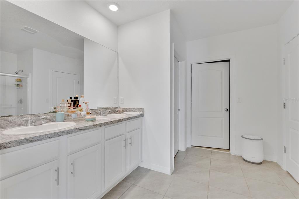 167 Eagleview Loop Davenport, FL 33837 - Photo 13 of 39 a bathroom with a granite countertop sink and a mirror