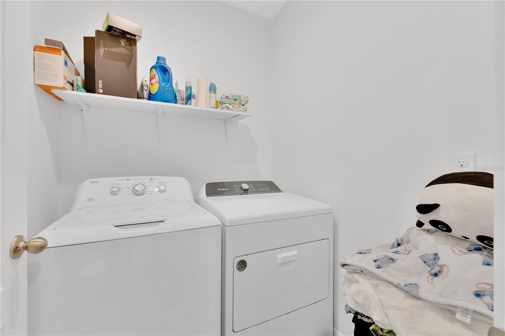 167 Eagleview Loop Davenport, FL 33837 - Photo 18 of 39 a utility room with dryer and washer
