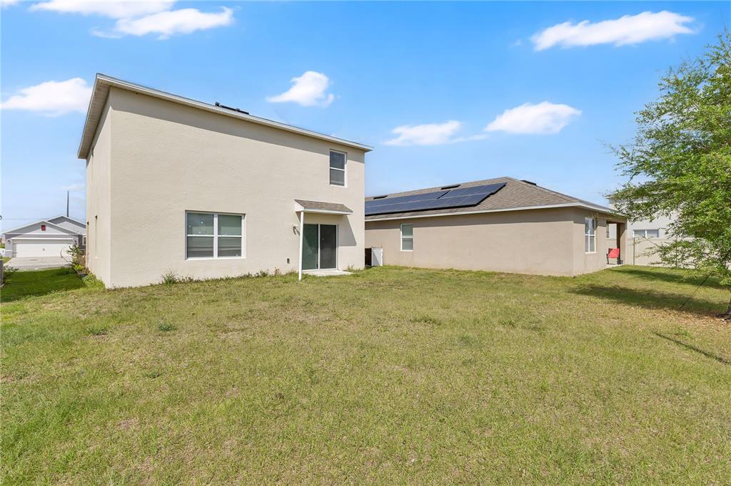 167 Eagleview Loop Davenport, FL 33837 - Photo 20 of 39 a view of a house with a backyard