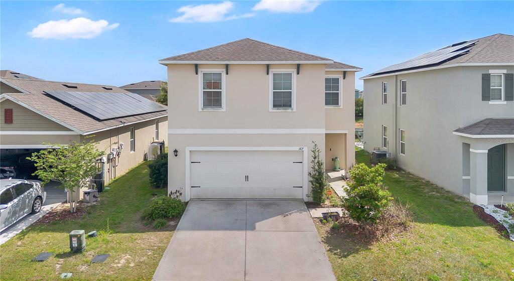 167 Eagleview Loop Davenport, FL 33837 - Photo 23 of 39 a front view of a house with garden