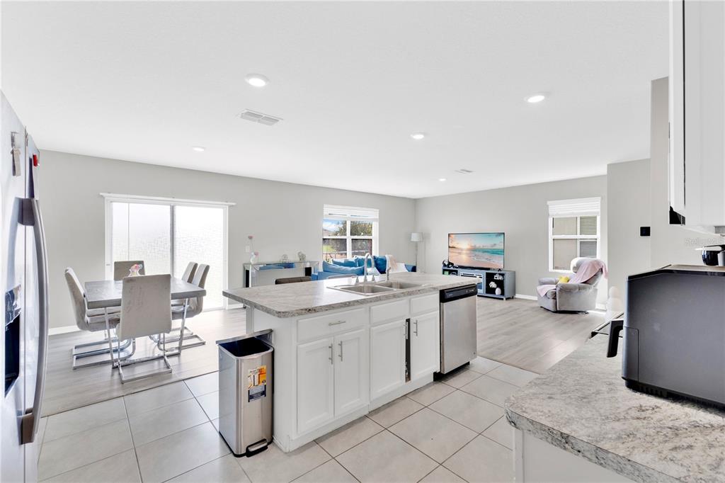167 Eagleview Loop Davenport, FL 33837 - Photo 9 of 39 a kitchen with sink cabinets and chair