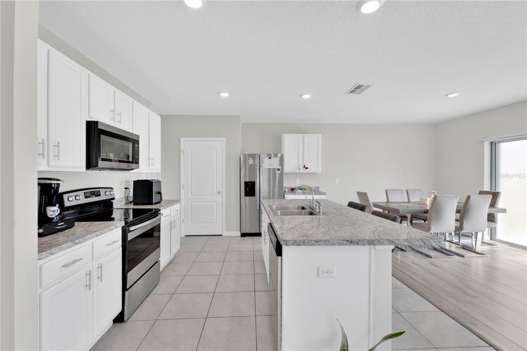 167 Eagleview Loop Davenport, FL 33837 - Photo 10 of 39 a kitchen with granite countertop white cabinets and stainless steel appliances