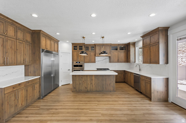 728 East Mountain Road North Ogden, UT 84414 - Photo 8 of 28 Spacious kitchen featuring extensive wood cabinetry, white countertops, a central island, recessed lighting, and stainless steel appliances