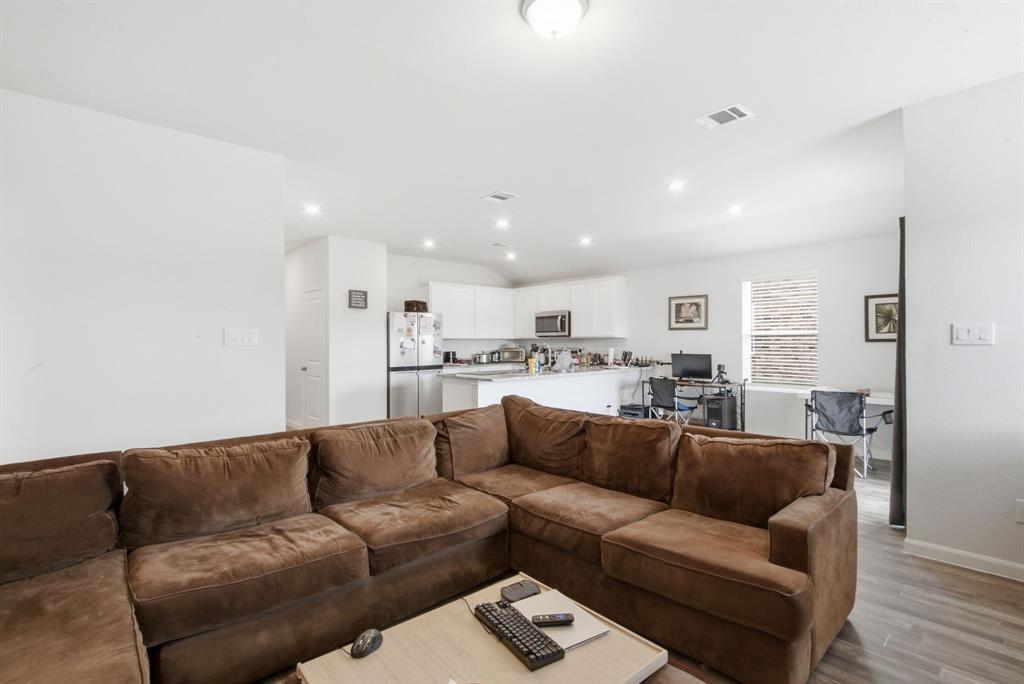 417 Jameson Springtown, TX 76082 - Photo 16 of 25 Open-concept living area with wood-finish flooring, recessed lighting, and white walls