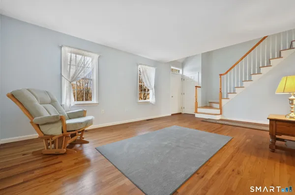 a view of a dining room with furniture window and wooden floor