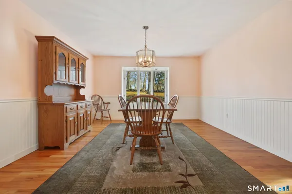 a large kitchen with wooden floors and stainless steel appliances