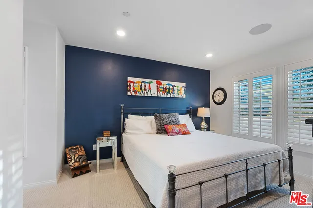 a bedroom with a bed and a chair