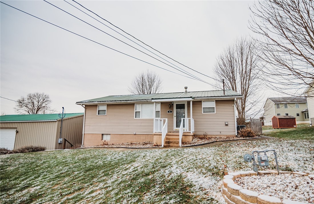 91 Mike Street Washington, WV 26181 - Photo 41 of 42 Single story home with a metal roof and a front lawn