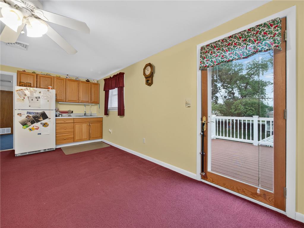 3046 Ridon Court Bethlehem, PA 18020 - Photo 40 of 41 A versatile space features a partial kitchen setup and direct access to an outdoor deck.