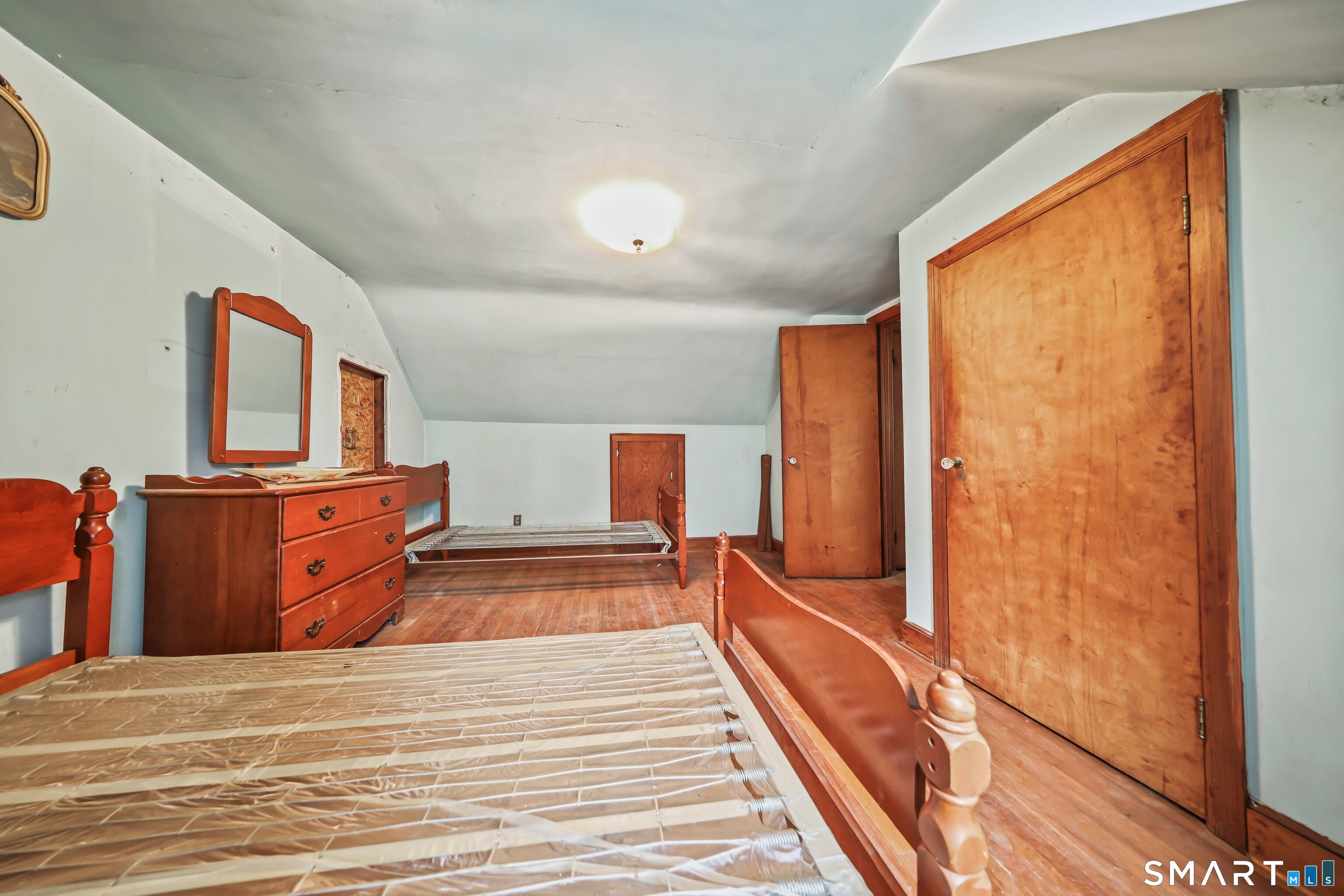 76 Clark Hill Road Prospect, CT 06712 - Photo 13 of 44 a bedroom with a bed and wooden floor