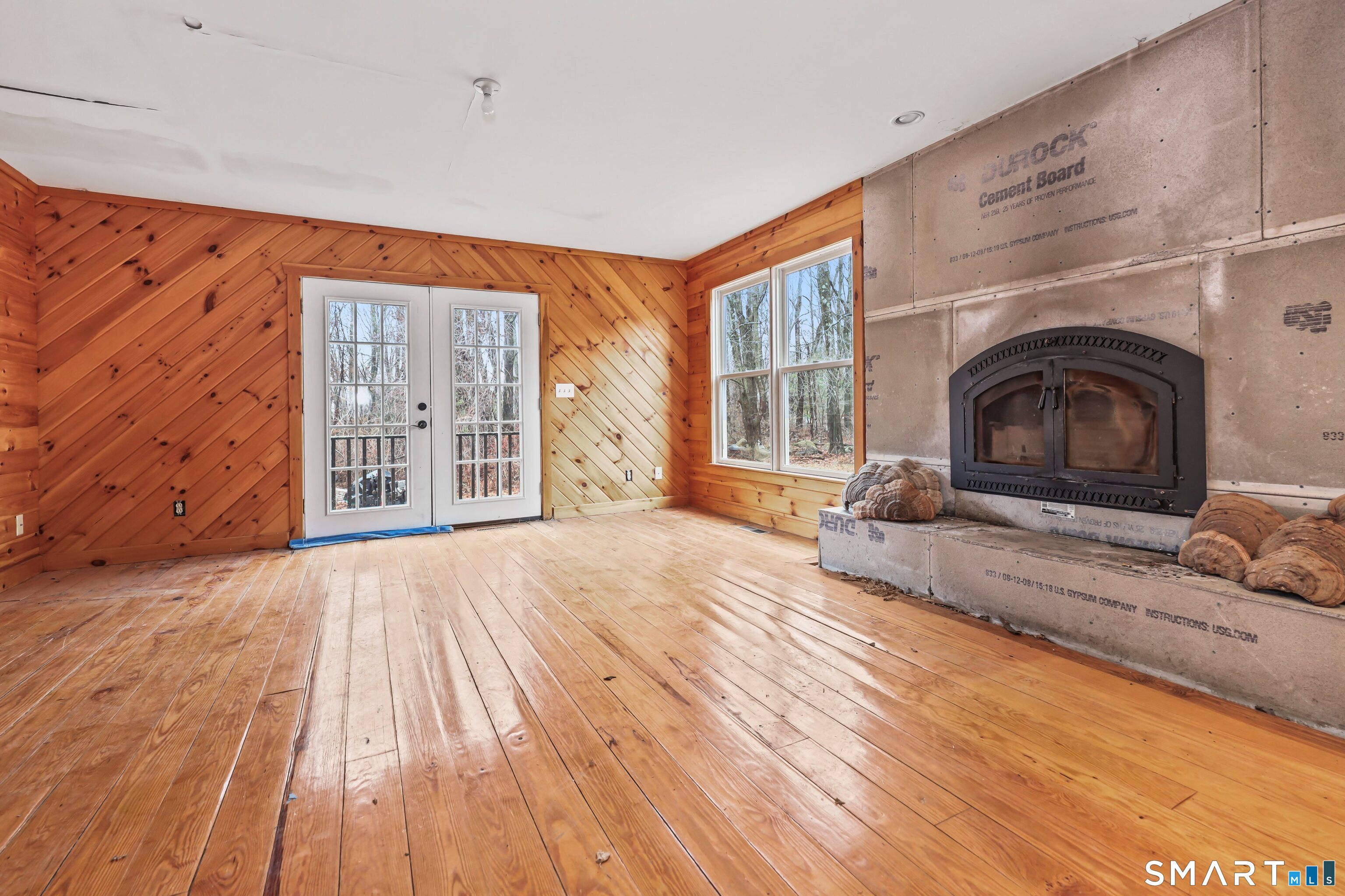 76 Clark Hill Road Prospect, CT 06712 - Photo 25 of 44 a living room with furniture a fireplace and wooden floor