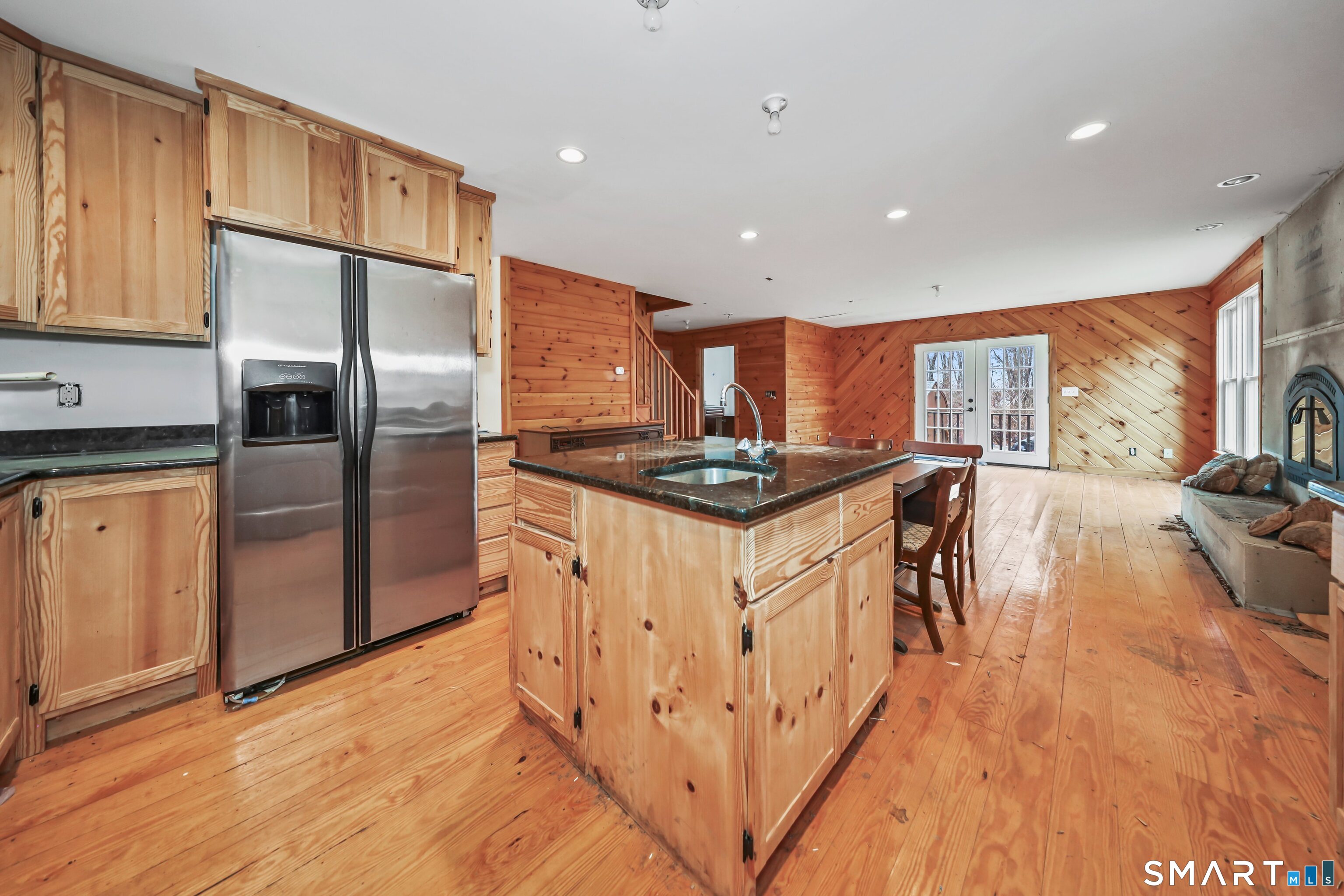 76 Clark Hill Road Prospect, CT 06712 - Photo 26 of 44 a kitchen with stainless steel appliances kitchen island granite countertop a refrigerator a stove and a wooden floors