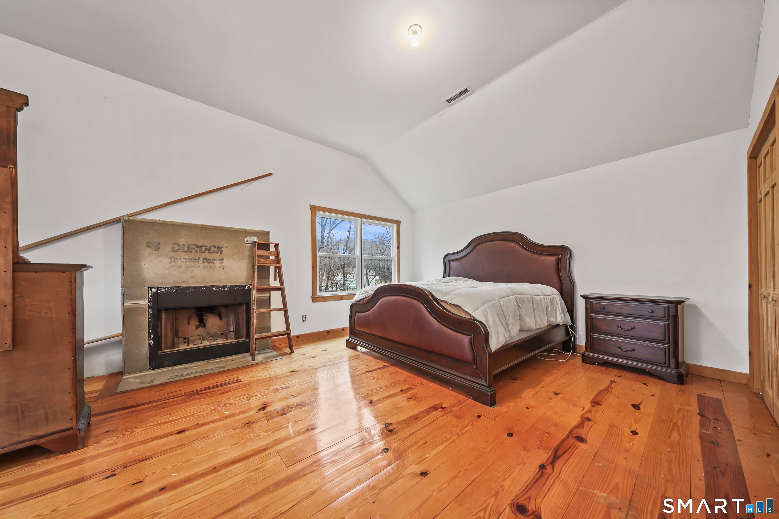 76 Clark Hill Road Prospect, CT 06712 - Photo 32 of 44 a bedroom with a bed and a fireplace