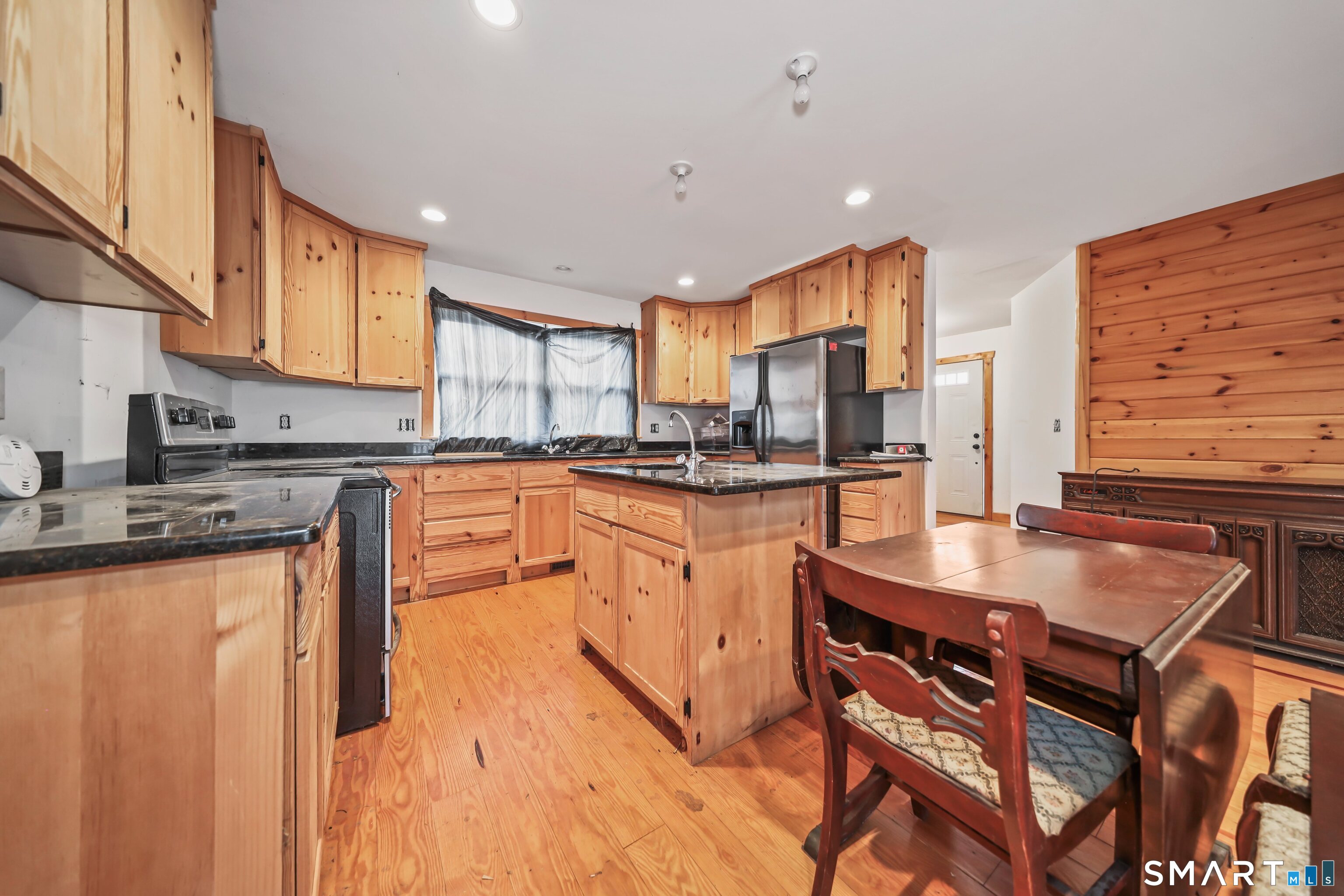 76 Clark Hill Road Prospect, CT 06712 - Photo 39 of 44 a kitchen with stainless steel appliances granite countertop a stove a sink and a refrigerator