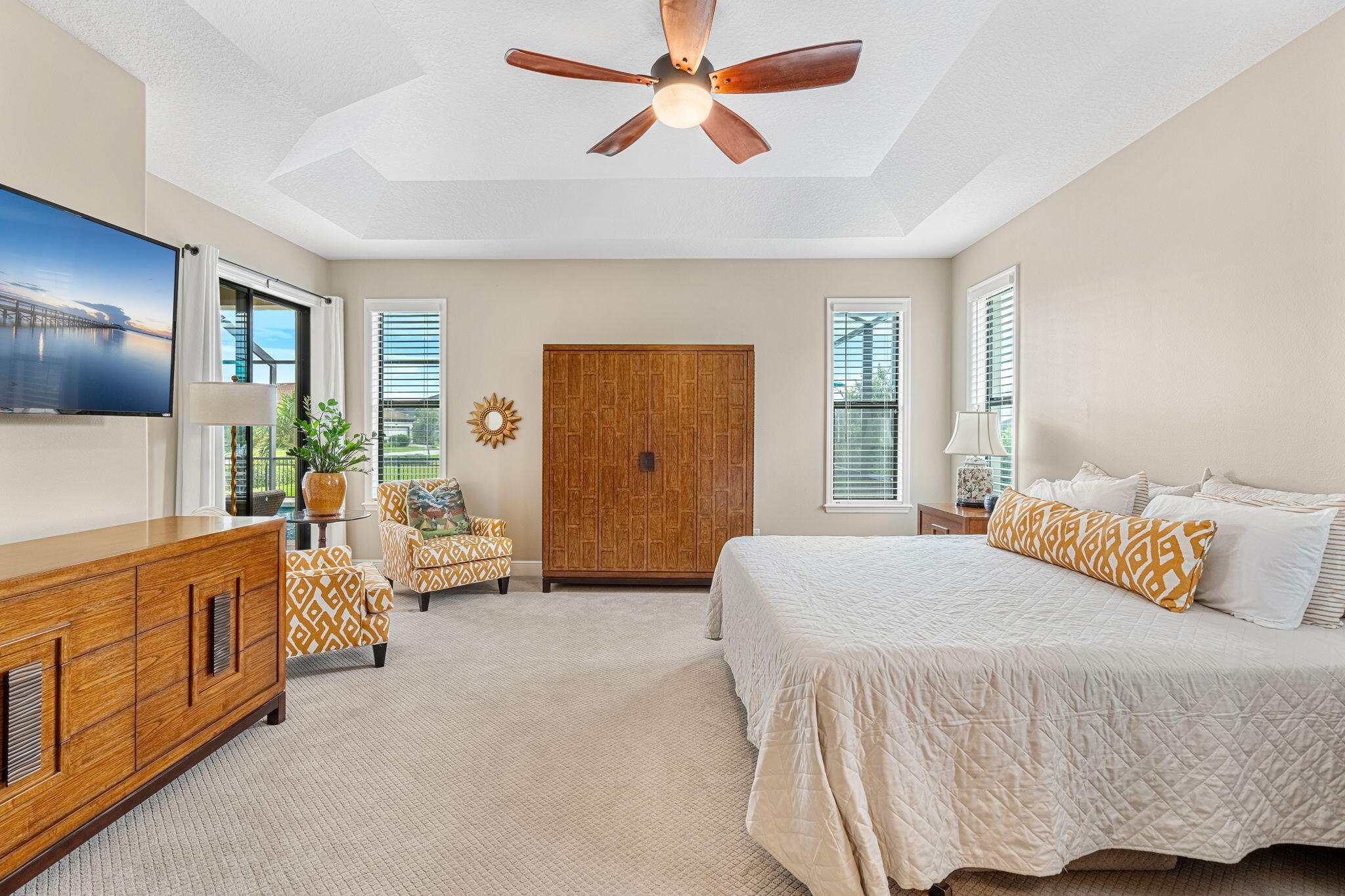 2911 Addison Drive Melbourne, FL 32940 - Photo 11 of 36 a bedroom with a balcony a bed and a chandelier