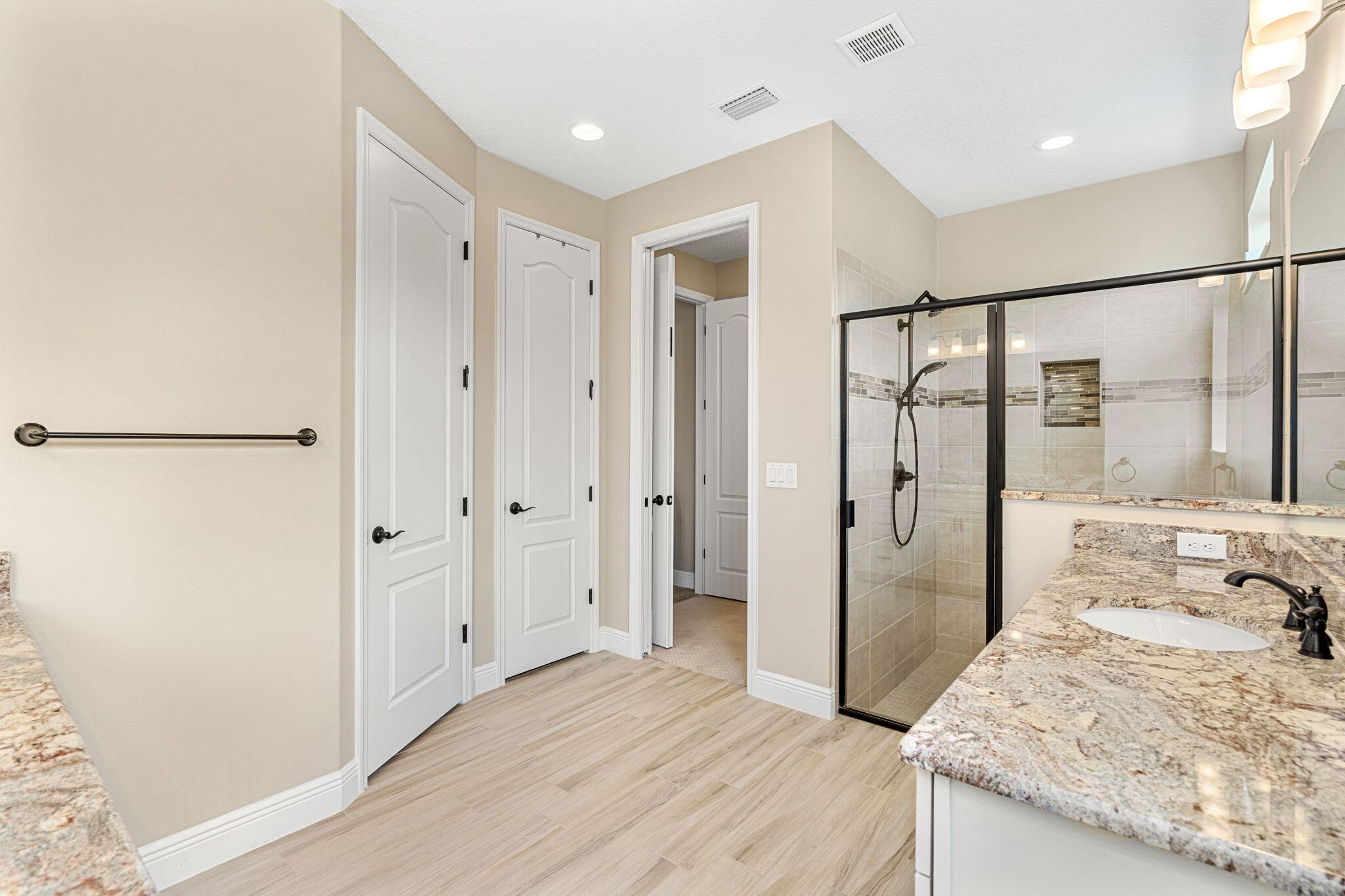 2911 Addison Drive Melbourne, FL 32940 - Photo 14 of 36 a bathroom with a granite countertop sink mirror and shower