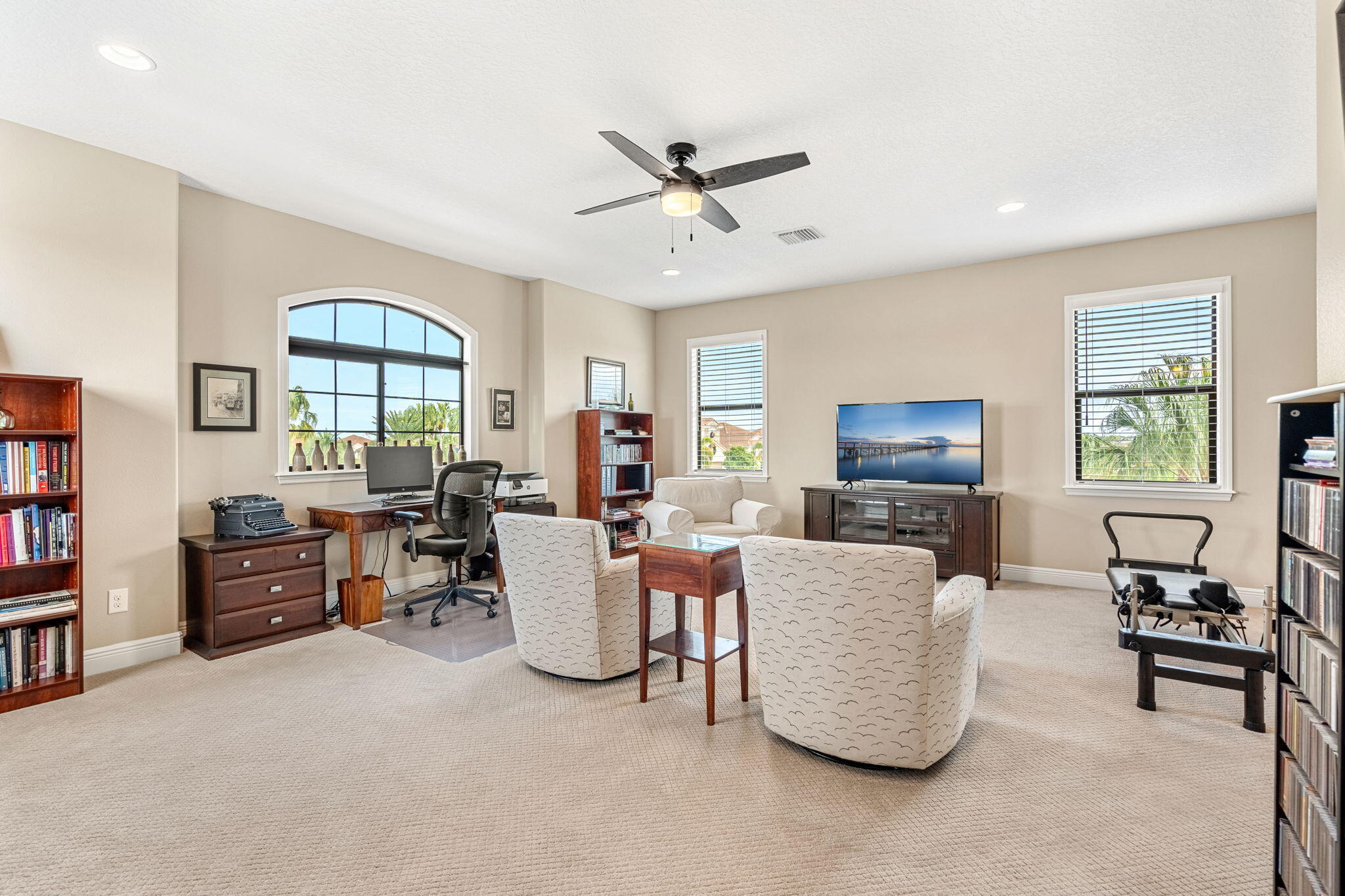 2911 Addison Drive Melbourne, FL 32940 - Photo 20 of 36 a living room with furniture a window and a flat screen tv