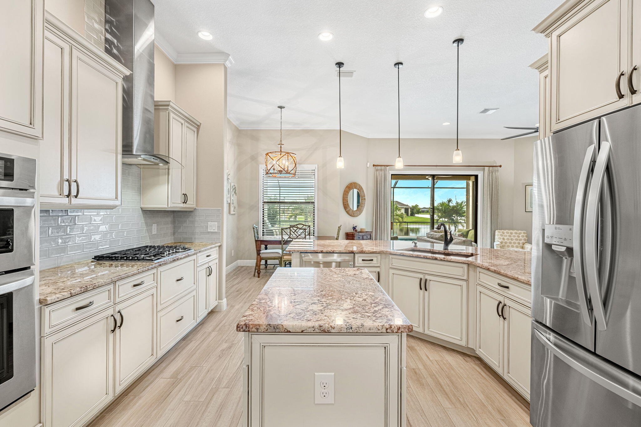 2911 Addison Drive Melbourne, FL 32940 - Photo 9 of 36 a kitchen with stainless steel appliances granite countertop a refrigerator a sink dishwasher a stove and white cabinets with wooden floor