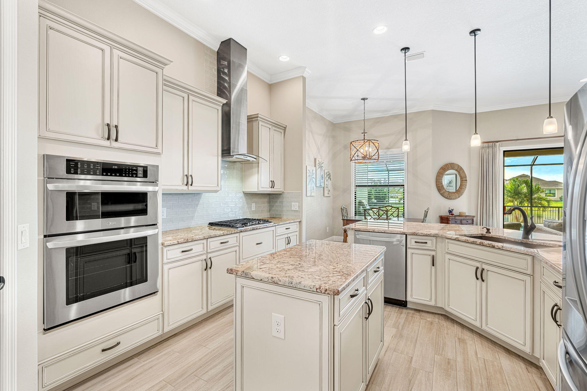 2911 Addison Drive Melbourne, FL 32940 - Photo 10 of 36 a kitchen with stainless steel appliances granite countertop a stove a sink and white cabinets with wooden floors