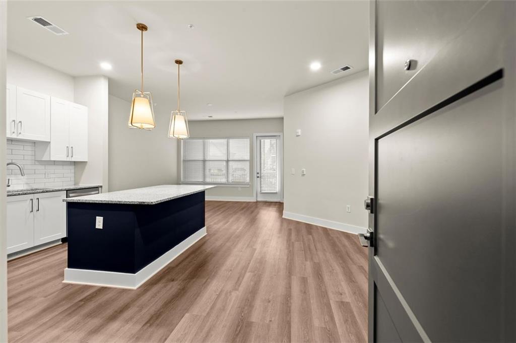 a large kitchen with wooden floor