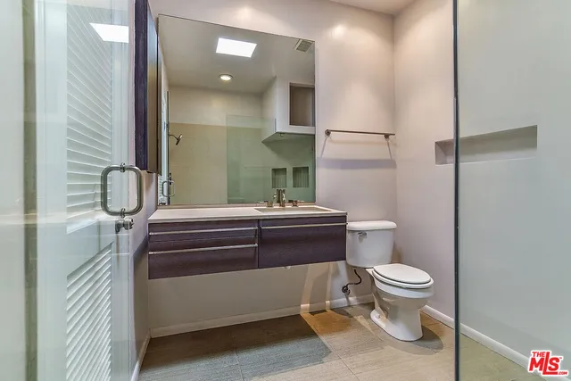 a bathroom with a toilet and a shower