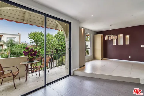 a view of an porch with furniture and floor to ceiling window