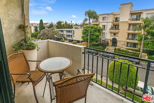 a balcony with table and chairs