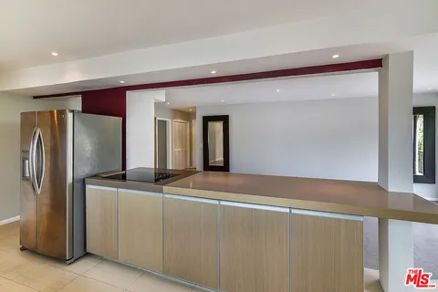 a view of kitchen with stainless steel appliances granite countertop cabinets and a refrigerator