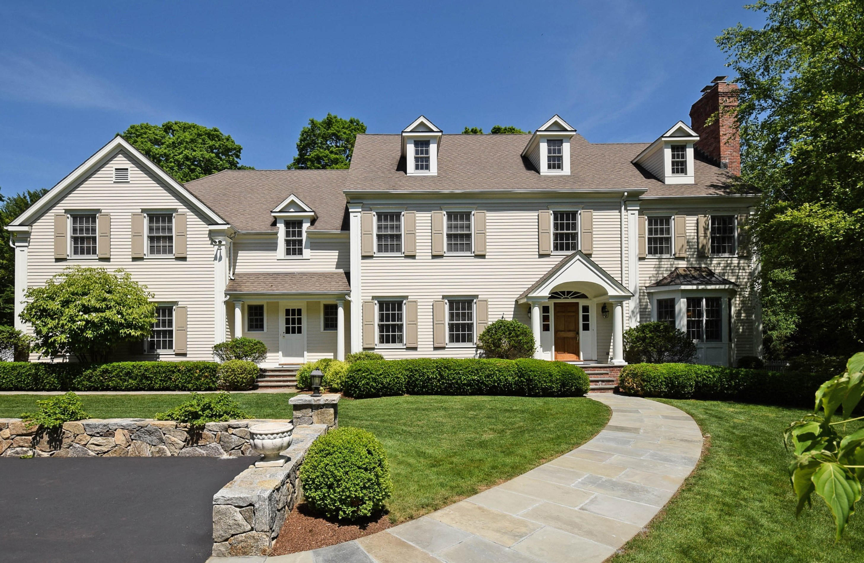 879 Valley Road New Canaan, CT 06840 - Photo 1 of 26 a front view of a house with a yard