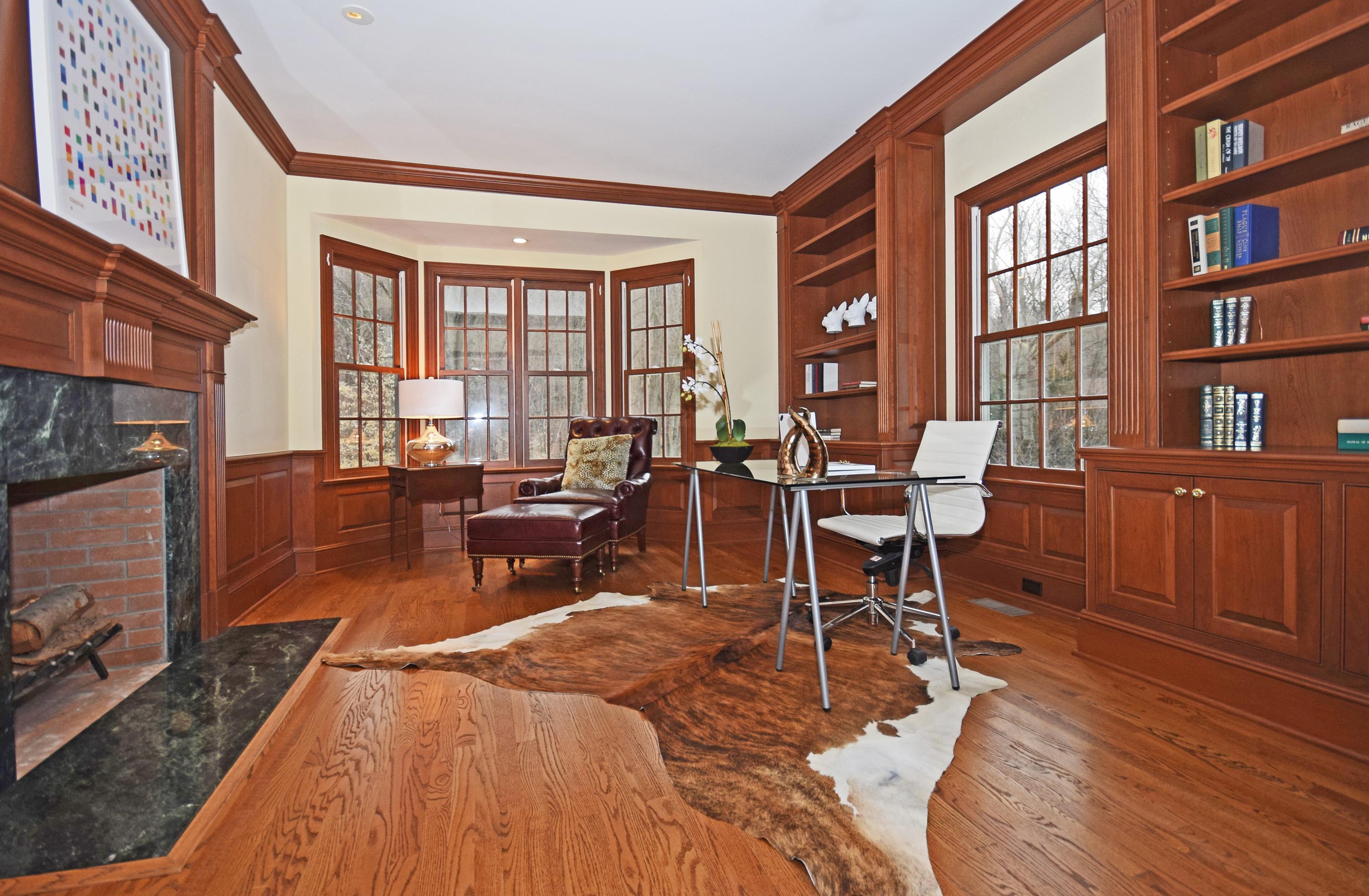879 Valley Road New Canaan, CT 06840 - Photo 12 of 26 a living room with furniture a rug wooden floor and a fireplace