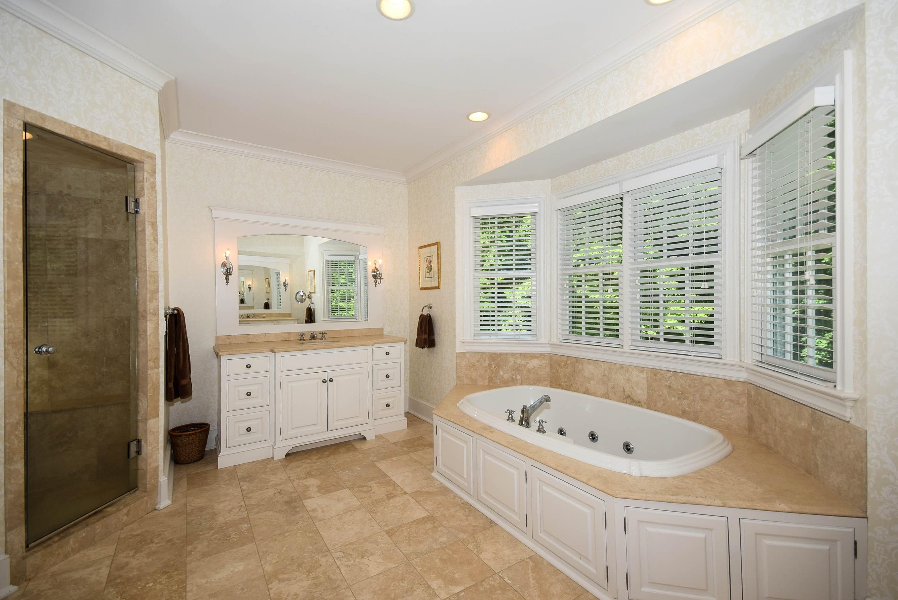 879 Valley Road New Canaan, CT 06840 - Photo 14 of 26 a bathroom with a bathtub sink and window