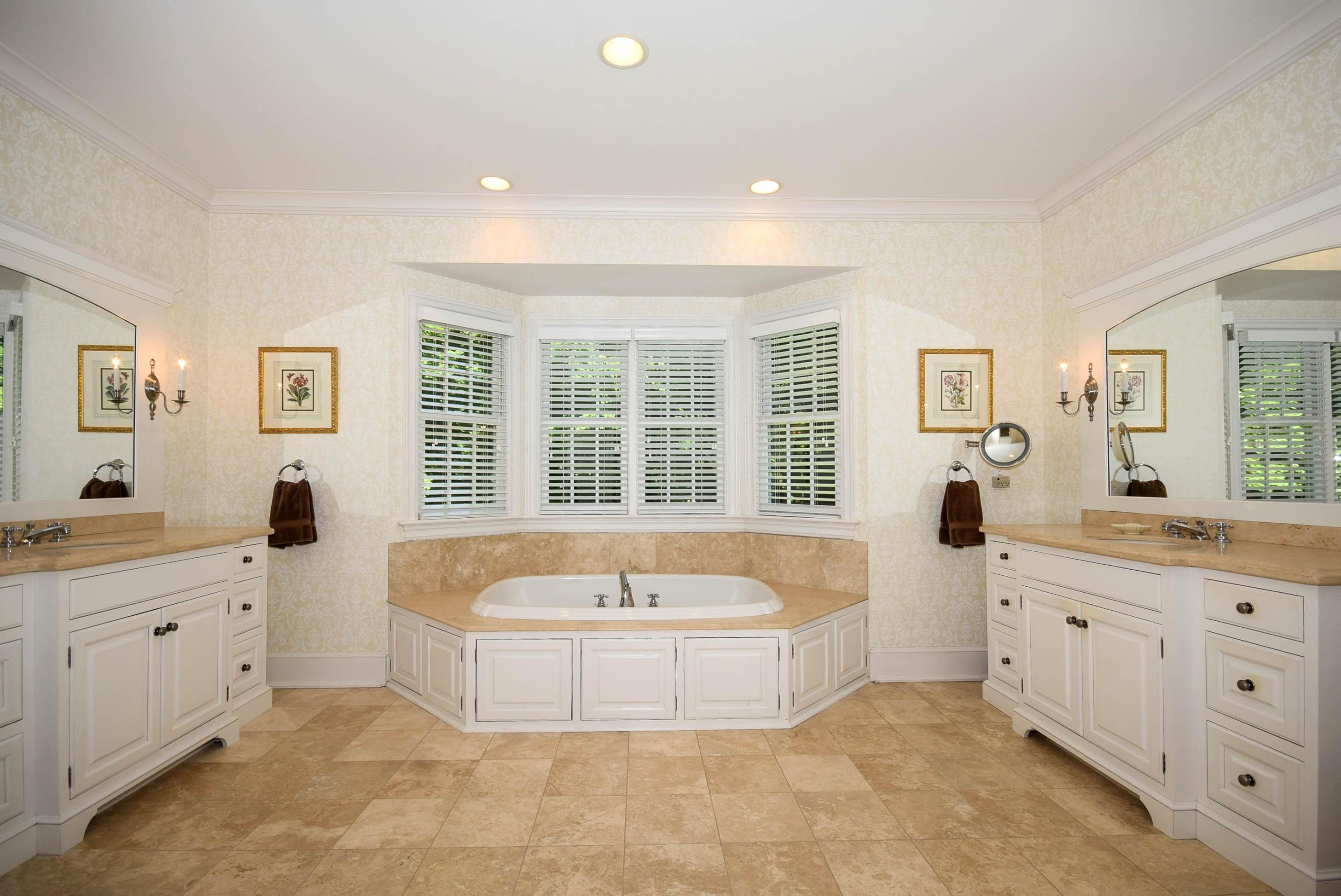 879 Valley Road New Canaan, CT 06840 - Photo 15 of 26 a spacious bathroom with a tub sink and mirror