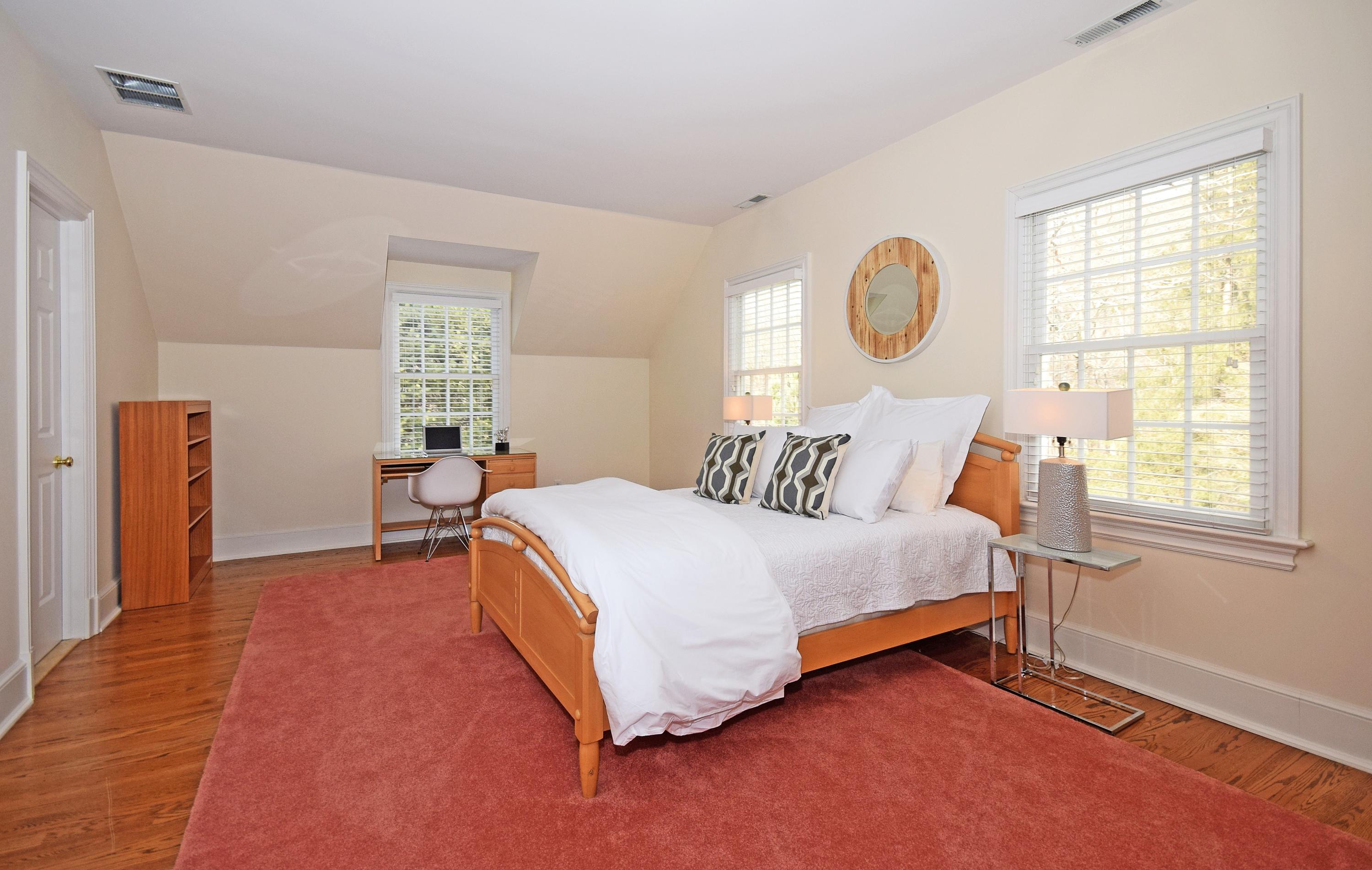 879 Valley Road New Canaan, CT 06840 - Photo 17 of 26 a bed room with a bed and a window
