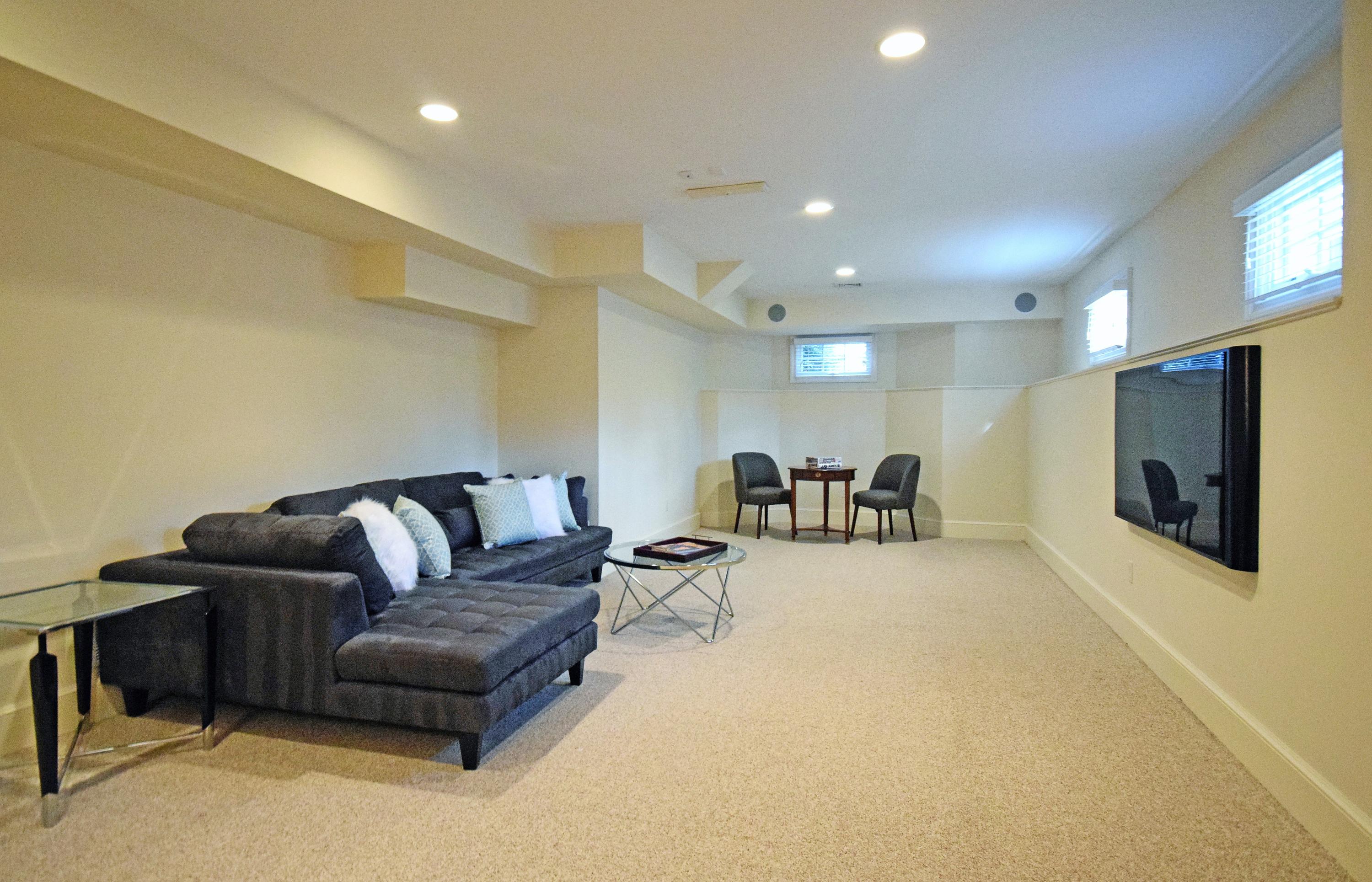 879 Valley Road New Canaan, CT 06840 - Photo 18 of 26 a living room with furniture and a flat screen tv