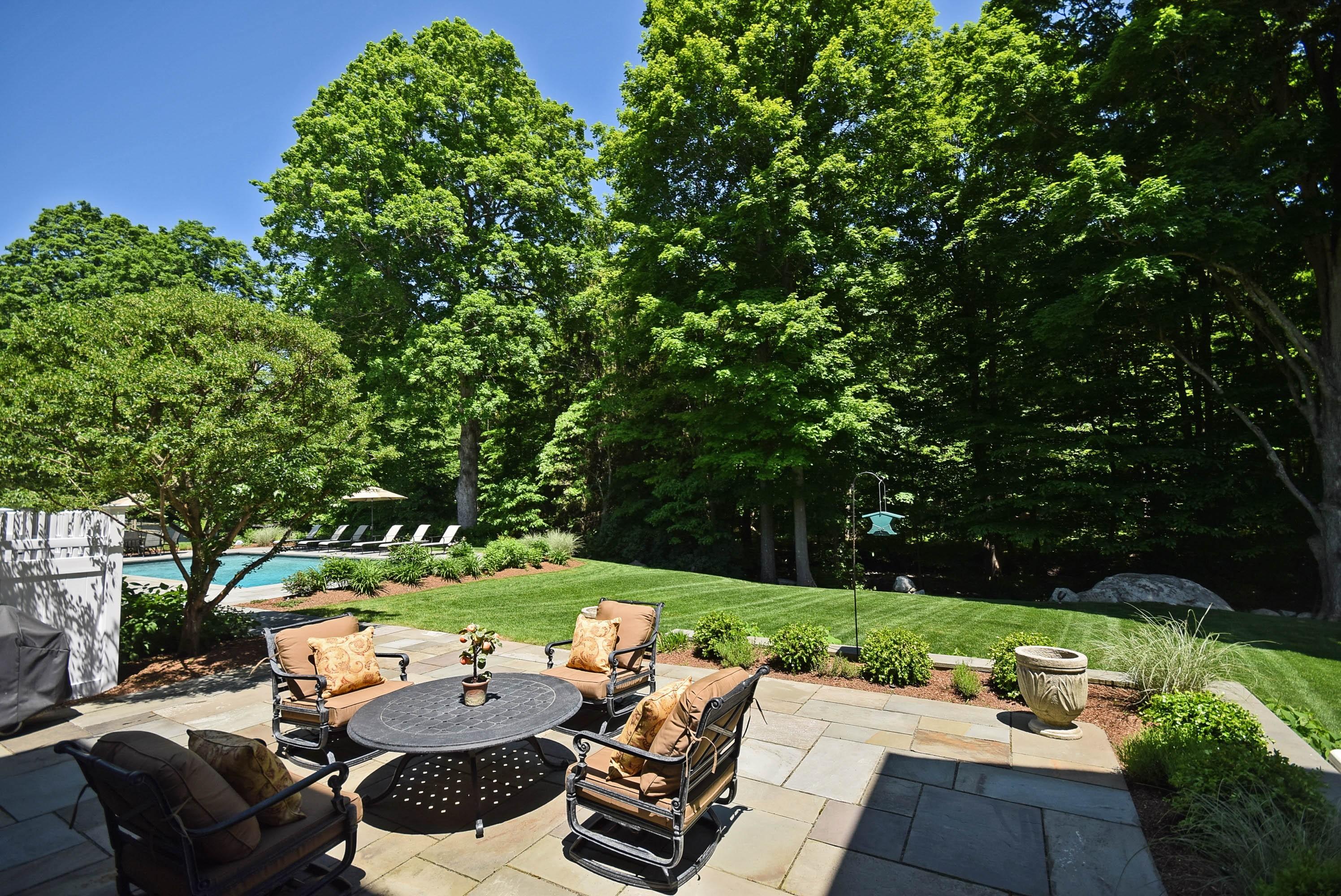 879 Valley Road New Canaan, CT 06840 - Photo 19 of 26 a yard with table and a chairs