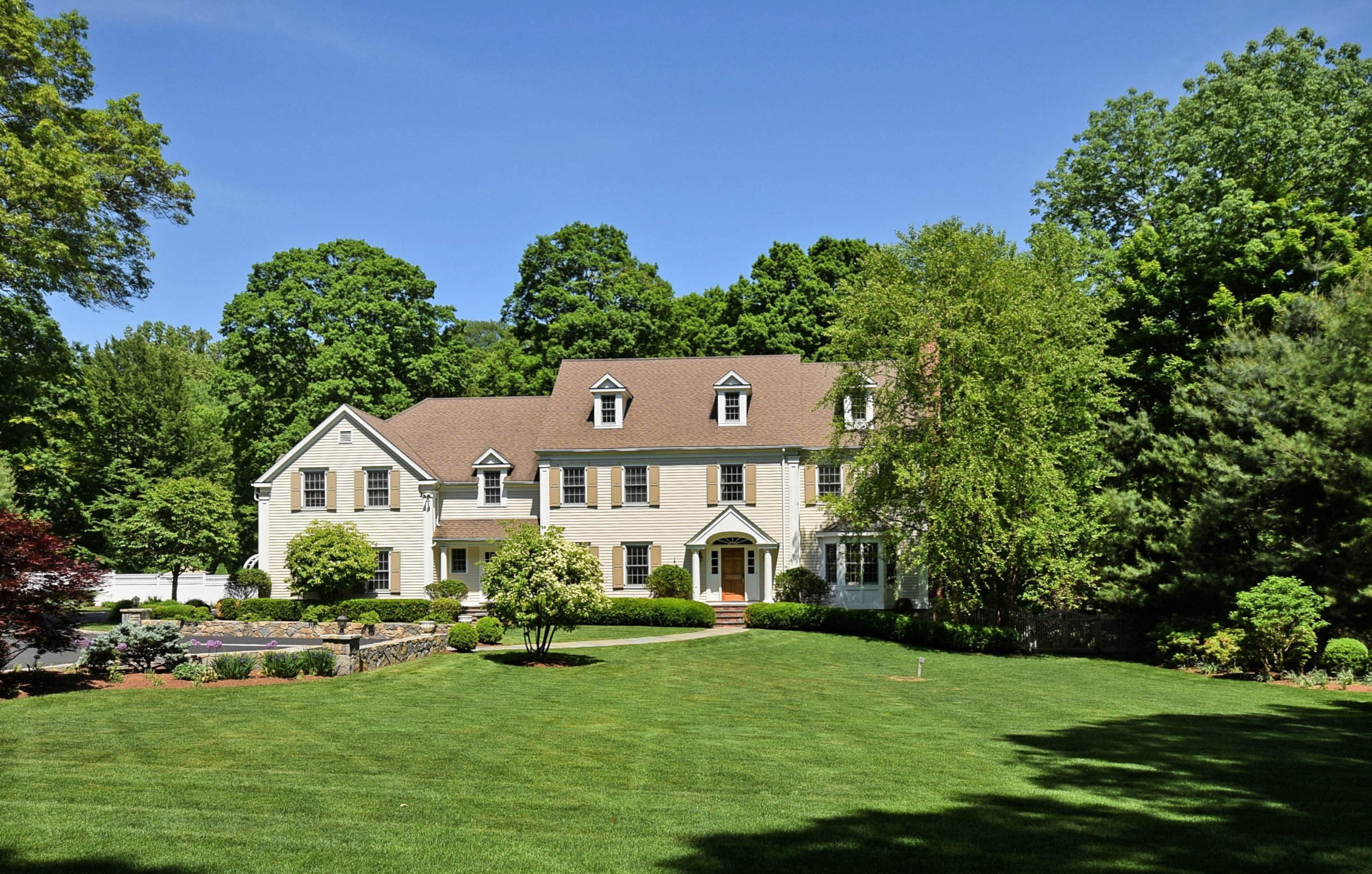 879 Valley Road New Canaan, CT 06840 - Photo 22 of 26 a view of a house with a big yard and potted plants
