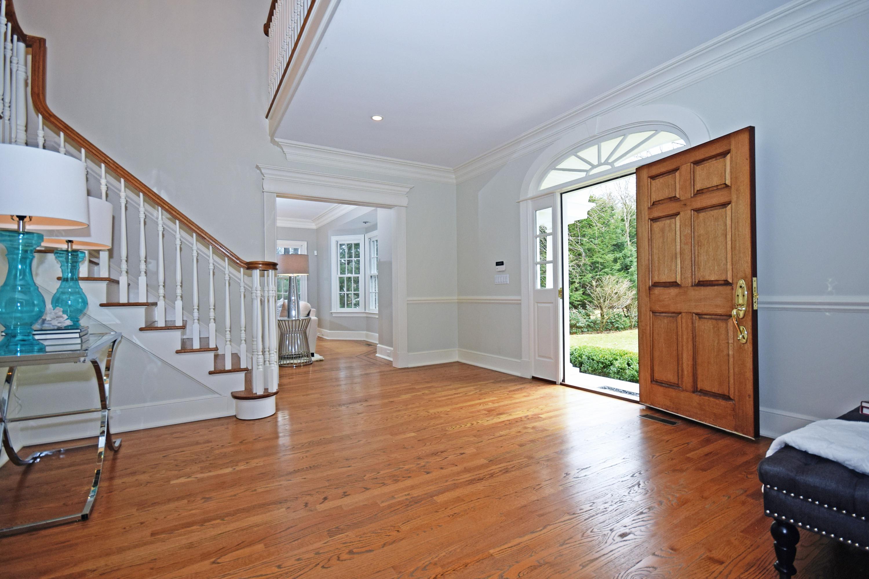 879 Valley Road New Canaan, CT 06840 - Photo 3 of 26 a view of empty room with wooden floor and fan