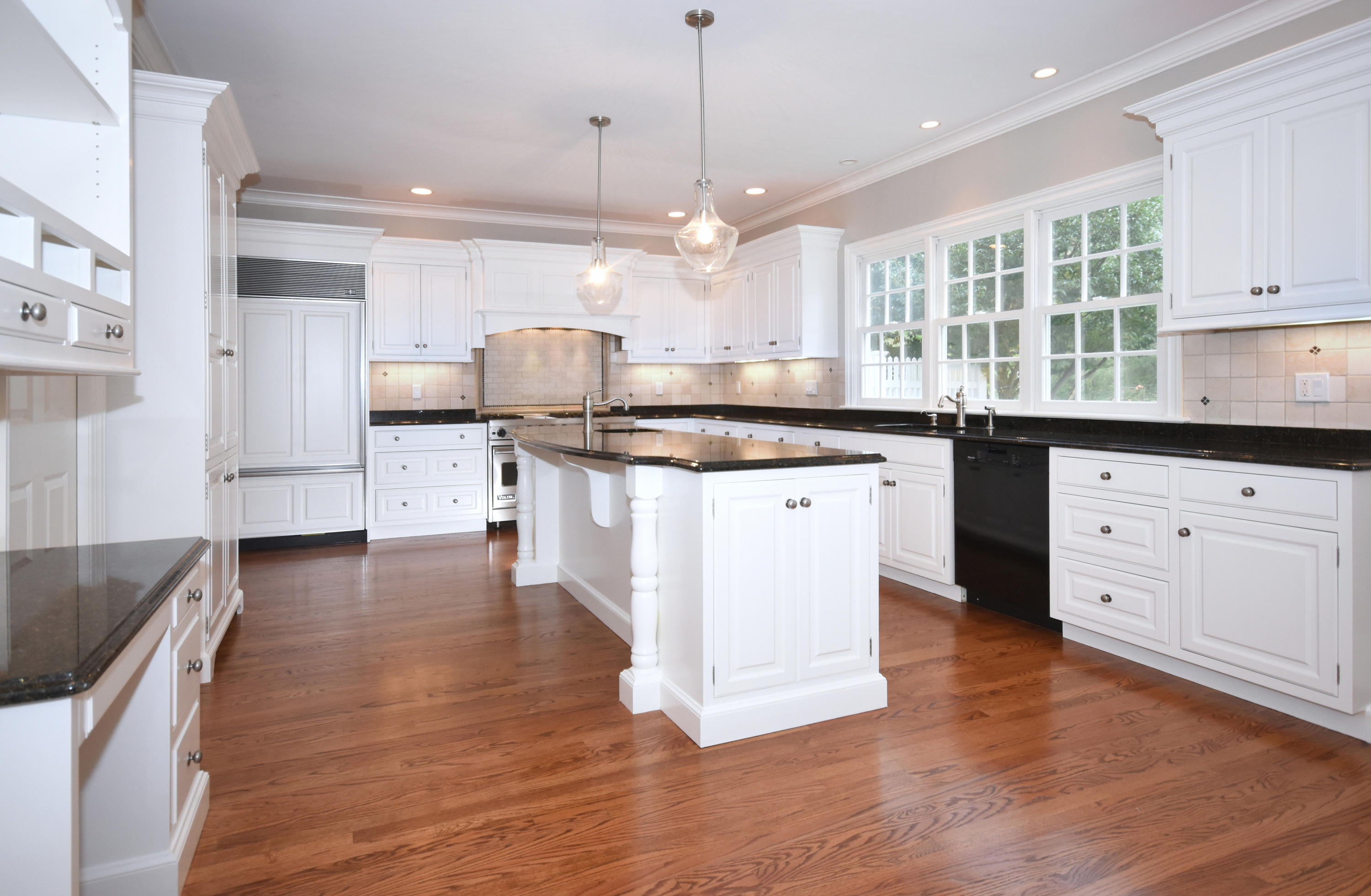 879 Valley Road New Canaan, CT 06840 - Photo 9 of 26 a kitchen with stainless steel appliances granite countertop a stove top oven a sink a center island and cabinets