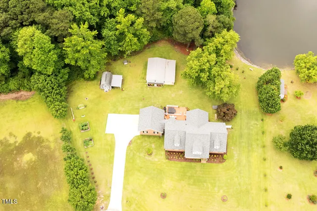 a front view of house with yard and trees in the background