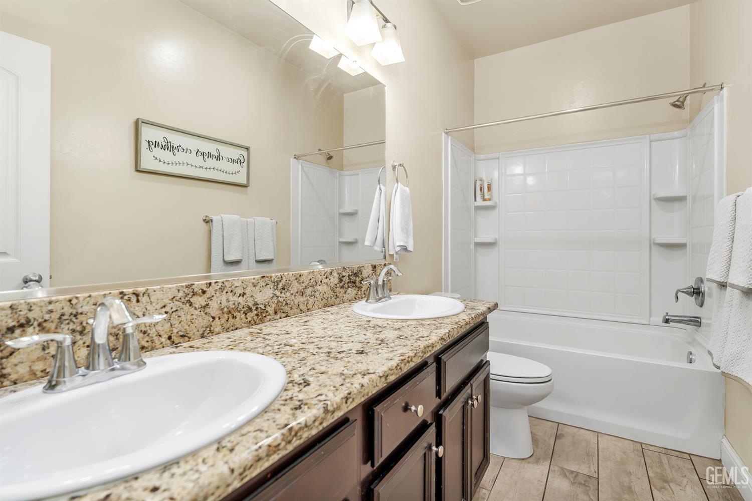 Undisclosed Address Shafter, CA 93263 - Photo 11 of 25 a bathroom with a granite countertop tub sink and mirror