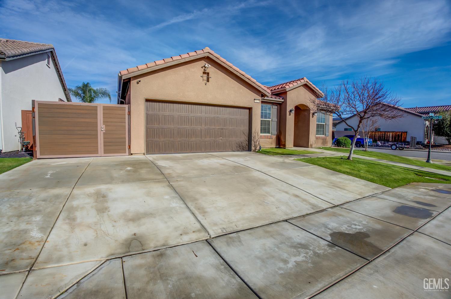 Undisclosed Address Shafter, CA 93263 - Photo 2 of 25 a front view of a house with a yard and garage