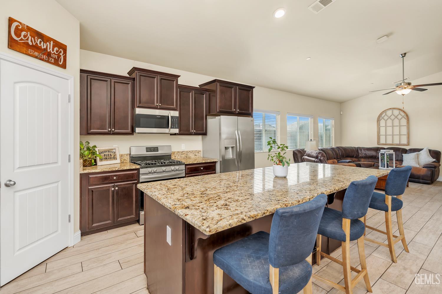Undisclosed Address Shafter, CA 93263 - Photo 5 of 25 a kitchen with granite countertop a stove refrigerator and cabinets