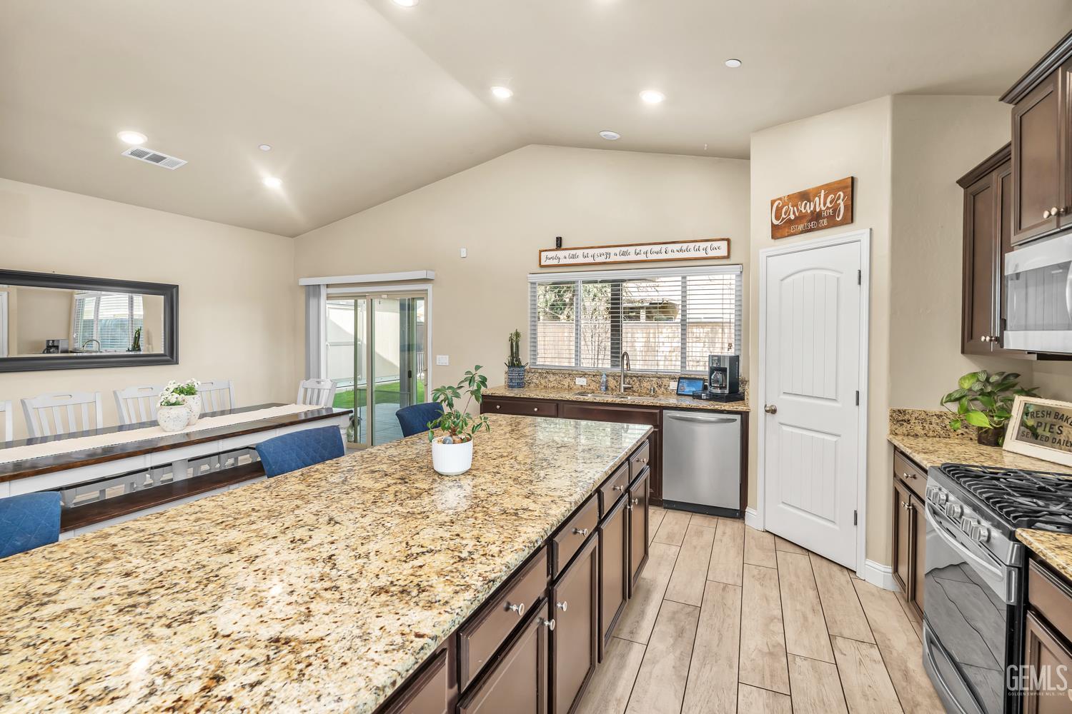 Undisclosed Address Shafter, CA 93263 - Photo 6 of 25 a kitchen with refrigerator cabinets and wooden floor