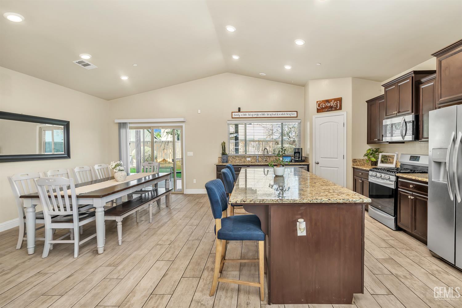 Undisclosed Address Shafter, CA 93263 - Photo 7 of 25 a dining hall with stainless steel appliances granite countertop a stove and a dining table with wooden floor