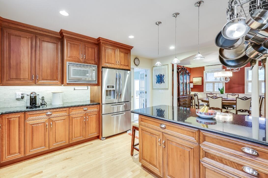 227 Run Hill Road Brewster, MA 02631 - Photo 20 of 89 a kitchen with stainless steel appliances granite countertop a sink a refrigerator and cabinets