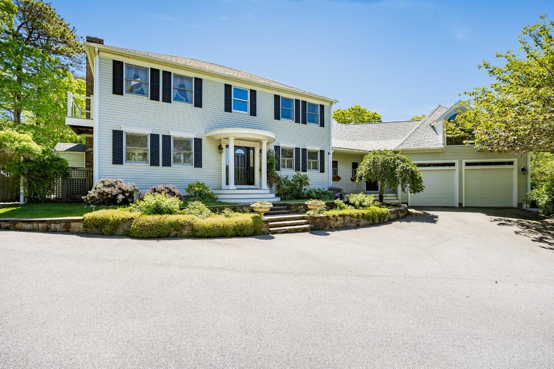 227 Run Hill Road Brewster, MA 02631 - Photo 2 of 89 a front view of a house with a garden and plants