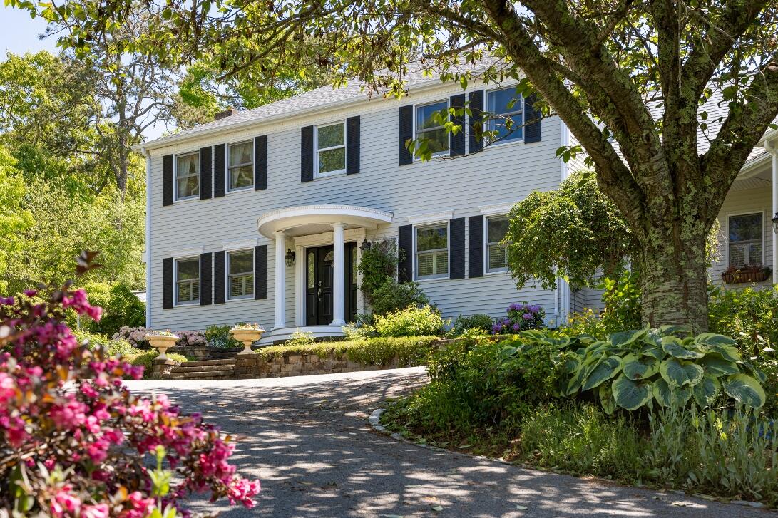 227 Run Hill Road Brewster, MA 02631 - Photo 4 of 89 a front view of a house with a yard and fountain